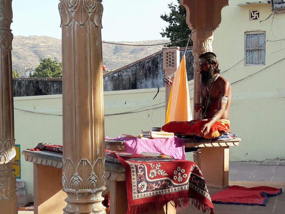 A monk meditating by Pushkar Lake.